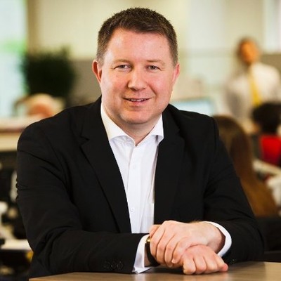 Mark sitting at a desk